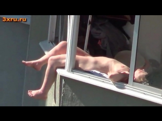 naked chick sunbathing on the balcony